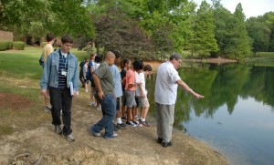VGCC instructor Phil Mondou (right) uses the large pond on the college’s Main Campus as a “laboratory” during a session at the 2012 Science Camp. (VGCC Photo)