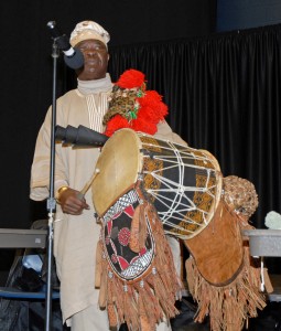 Prof. Bisi Adeleke, an ethnomusicologist, performs the Nigerian “talking drum” during a presentation at VGCC’s Main Campus on Feb. 25. He is seen here playing the so-called “daddy drum,” the largest of three drums, which traditionally was used only to awaken kings each morning at their palaces. (VGCC photo)