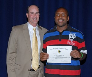 From left, VGCC men’s basketball Coach Mike Rotolo presents an award to player Justin Martin. (VGCC photo)