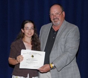 From left, player Becky Anderson receives an award from VGCC golf Coach Bobby Paff. (VGCC photo)