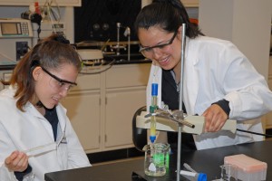 High school students (from left) Susana Garcia and Georgina Vanegas examine Green Fluorescent Protein at the VGCC Biotech Workshop. (VGCC photo)