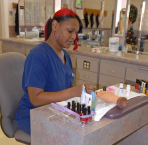 Tonette Khalil-ullah practices nail techniques in a VGCC Cosmetology lab. (VGCC photo)