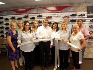 Shown at the Henderson-Vance Chamber of Commerce ribbon cutting for REW Medical Wear and Tanning, are, from left, Front row: Erica Easterling;,Nathan Stewart, Owner REW Medical Wear and Tanning; Michelle Royster; Clareese Moss, New You with Shortcakes; Second Row: Annette Roberson, Henderson-Vance Chamber of Commerce Director of Membership; Sheri Jones, Henderson-Vance Chamber of Commerce Communications Consultant; Cheyenne Williamson; Lauren Long; Tommy Hester, Chair, Vance County Board of Commissioners; Roberta Freeman.