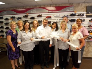 Shown at the Henderson-Vance Chamber of Commerce ribbon cutting for REW Medical Wear and Tanning, are, from left, Front row: Erica Easterling;,Nathan Stewart, Owner REW Medical Wear and Tanning;  Michelle Royster; Clareese Moss, New You with Shortcakes; Second Row: Annette Roberson, Henderson-Vance Chamber of Commerce Director of Membership; Sheri Jones, Henderson-Vance Chamber of Commerce Communications Consultant; Cheyenne Williamson; Lauren Long; Tommy Hester, Chair, Vance County Board of Commissioners; Roberta Freeman.