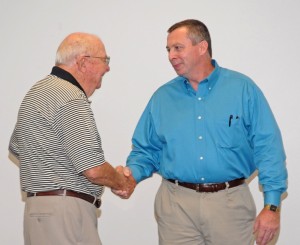 VGCC Board of Trustees member Donald Seifert, Sr. of Henderson (left) congratulates Gene Purvis at his retirement reception. (VGCC photo)