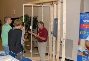 VGCC Electrical Systems Technology program head Robert Hudson (center) showed students a model that demonstrated residential electrical wiring during the Applied Technologies Expo. (VGCC photo)