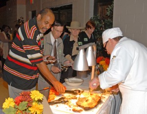 Stacey Smith of Oxford (right), a VGCC Culinary program graduate and member of the advisory committee for the Workforce Investment Act department, prepares to sample beef brisket prepared by current Culinary students for the reception preceding the advisory committee meetings. (VGCC photo)