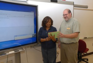 From left, VGCC student Donnie Jones of Creedmoor and Web Technologies instructor Steven Sievert examine an app on an iPad tablet in a computer lab on the college’s Main Campus. (VGCC photo)