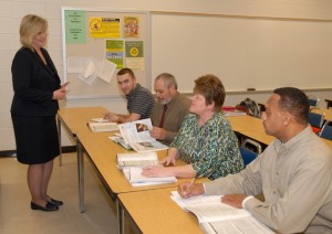 Certified Production Technician (CPT) training instructor Pamela Huff (standing) teaches students (from left) Michael Evans of Warrenton, Edwin Garrigo of Henderson, and Sharon Norwood and Obie Oakley, both of Oxford, in a classroom at VGCC’s Main Campus. (VGCC photo)