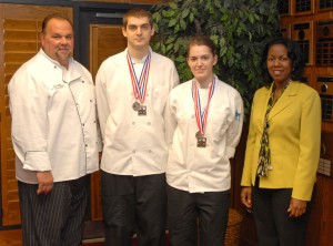 From left, Chef Ross Ragonese, students Matthew Hosier and Shiona MacLean (wearing the medals won at the competition) and VGCC President Dr. Stelfanie Williams. (VGCC photo)