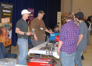 At the Advanced Manufacturing Career Awareness Day, VGCC Welding Technology students Jay Johnson and John-Paul Bresett, both of Henderson, talk with high school students and point out some of the equipment they use for training. (VGCC photo)