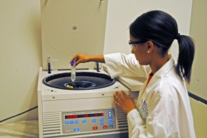 High school student Armani Grillo places a solution into a centrifuge during the VGCC Biotech Workshop. (VGCC photo)