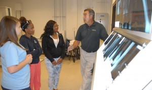 Bobby Austin, head of the VGCC Radiography program (right), talks with Mini-Medical School students in his program’s lab at the college’s South Campus. (VGCC photo)