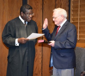District Court Judge J. Henry Banks Jr. from the Ninth Judicial District of North Carolina, left, swears in L. Opie Frazier Jr. of Henderson for a four-year term on the Vance-Granville Community College Board of Trustees. Frazier, a former board chair, is the longest serving member of the board. He was a board member from 1971 to 1996 and came back on the board in 2002 as a Vance County Board of Education appointee. (VGCC photo)