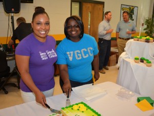 From left (in foreground), VGCC students Tonya Parrish of Henderson and Ambrianna Winston of Warrenton serve “birthday” cake during the college’s 45th anniversary celebration. Parrish is a College Transfer student, while Winston is enrolled in the Office Administration program. Both work part-time for the college through the Work-Study program. (VGCC photo)