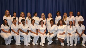 Graduates honored at the VGCC Practical Nursing pinning ceremony included, seated, from left: Martina Usher, Felicia Spruill, Taja Green, Tonya Sneed, Rhonda Riley, Lovelyn Imoh, Colby Johnson, Melissa Ramos and Kenneth Foy; standing, from left: Lydia Travis, Wanda Davis, Jamie Clopton, Brittany Champion, Tonya McLeod, Lisa Thomsen, Susan Collins, Charidy Scott, Rachel Campbell, Lillian Lowery and Daniel Ongeri. Not pictured: Leonidah Momanyi. (VGCC photo)