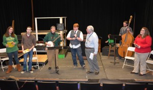 Rehearsing a song from “Smoke on the Mountain” are, from left, Jessie Hartley of Oxford, Morgan McFalls of Oxford, Button Brady of Clarksville, Va., Spencer Nunn of Warrenton, Rev. Pat Cox of Oxford, Sidney Henderson of Henderson (in background on piano), Derek Jones of Henderson (on bass) and Lauren Elliott of Oxford. (VGCC photo)