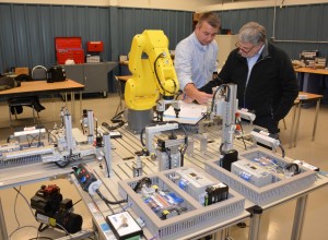 From left, Roger Giddens, a consultant from Moultrie Technical College in Georgia, trains VGCC Mechatronics program head/instructor Keith Shearon on the operating features of the MAS-200 Modular Assembly System produced by SMC. (VGCC photo)