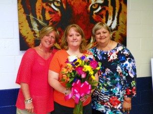 Pulley is shown at the center of the accompanying photo holding her flowers as she is joined by McKoon, left, and Darden.