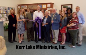 Shown at the Henderson-Vance Chamber of Commerce ribbon cutting for Kerr Lake Ministries, Inc. are, Sandy Poythress, Kerr Lake Ministries; HVCC Board Chair Tonya Evans, Duke Energy; Archie Taylor, Vance County Commissioners Chairperson; Clark Simpson and Susan Sears, Kerr Lake Ministries, Inc.; Mayor Pete O’Geary; Joyce Doughty, Tots 'N More Consignment Boutique; Sierra and Miranda Yount; Brittany Hedgepeth; Bobby Williams; Christy Buchanan; Chamber Ambassador Kevin Bullock, WIZS 1450 AM Radio; Chamber Ambassador Joan Robinson, Kittrell Job Corps Center; HVCC President John Barnes; and other friends of Kerr Lake Ministries, Inc.  Not Pictured: HVCC, Office Manager Melanie Mann; HVCC Director of Membership Services, Annette Roberson; and Jenny Hester, PRIM Development and Rentals.