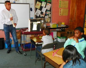 Bobby Austin, a radiology instructor at Vance-Granville Community College, holds a human bone replica as he shows an x-ray and talks about how radiology services help doctors to treat their patients.
