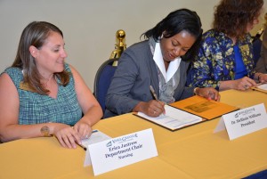Dr. Stelfanie Williams, president of Vance-Granville Community College, signs an agreement to launch the North Carolina Piedmont “Regionally Increasing Baccalaureate Nurses” (RIBN) initiative with N.C. A&T State University, Davidson County Community College and Guilford Technical Community College in a ceremony at A&T on Monday, June 1. Also signing from VGCC was Erica Jastrow, the department chair for Nursing, shown at left. (VGCC photo)