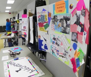 The first photo, shows a parent in the background looking at one section of the student projects on display during the STEM Extravaganza on May 30