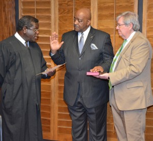 District Court Judge J. Henry Banks Jr. from the Ninth Judicial District of North Carolina, left, administers the oath of office to Abdul Sm Rasheed for a four-year term on the Vance-Granville Community College Board of Trustees. Rasheed was reappointed by the Vance County Board of Education. Assisting in the swearing-in is VGCC Board Attorney Jerry Stainback, right. (VGCC photo)