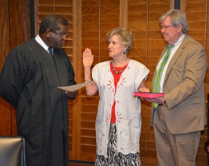 District Court Judge J. Henry Banks Jr. from the Ninth Judicial District of North Carolina, left, swears in N. Annette P. Myers for a four-year term on the Vance-Granville Community College Board of Trustees. Myers was reappointed by the Granville County Board of Commissioners. Assisting in the oath is VGCC Board Attorney Jerry Stainback, right. (VGCC photo)