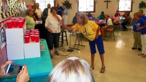 Assistant Principal Ann Hancock attempts a ping pong ball toss.