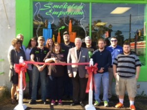 Shown at the Henderson-Vance Chamber of Commerce ribbon cutting for Smokeless Emporium are, (front row) Vanessa Jones, HVCC Work First Coordinator; Josh Gilley and Julie Moore, Smokeless Emporium; Mayor Pete O’Geary; Tyler White; Matthew Hatchel; (back row) John Barnes, HVCC President; Heather Tuck; Megan Lee; Brian and Daniel Moore, Smokeless Emporium; Chamber Ambassador Kevin Bullock, WIZS 1450.. Not Pictured: Melanie Mann, HVCC Office Manager