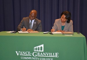 From left, Dr. Johnson O. Akinleye, provost and vice chancellor for academic affairs of North Carolina Central University, and Dr. Stelfanie Williams, president of Vance-Granville Community College, formally sign an agreement outlining the “Eagle Voyage” partnership between their respective institutions, at a ceremony held in the VGCC Civic Center on Dec. 2. (VGCC photo)