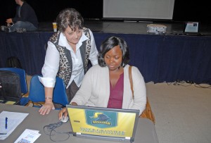 VGCC Computer Education program head/instructor Faith Harris (standing) helps Paralegal Technology student Caisha Renee Vann of Henderson sign up to join the SkillsUSA chapter. (VGCC photo)