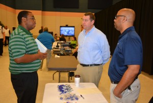 VGCC Computer Technology Integration student Chris Davis of Oxford (left) talks with Daniel Andre and Bernard Robinson, both from ATOS, an information technology company in Boydton, Va., during the Business Technologies Fair. (VGCC photo)