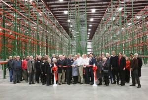 MARK DOLEJS / Dispatch staff Mike Williams, founder of M.R. Williams, addresses the crowd gathered for the ribbon cutting and grand opening of their new warehouse space. In the coming days, the company will be using the new expanded facility, which includes 90,000 square feet of dry warehouse and 10,000 square feet of freezer space. Shown at the Henderson-Vance Chamber of Commerce ribbon cutting for M.R. Williams, Inc. are, Company owner Mike Lawson and spouse Jerry Williams; Director of Operations Carl Fisher; Warehouse Manager Bobby Eatmon and other team members of M.R. Williams, Inc.; Mayor Eddie Ellington; Vance County Commissioner Chair Gordon Wilder; Vance County Commissioners Archie Taylor and Terry E Garrison; City Council members Garry Daeke, George M. Daye, Marion Williams; Chamber Ambassador Kevin Bullock, WIZS 1450 AM; Chamber Ambassador Tonya Moore, KARTS; Chamber Ambassador Michael Bobbitt; Vance County Economic Development Stuart Litvin and other business leaders and friends; . Not Pictured: HVCC President John Barnes; HVCC Director of Membership Services, Annette Roberson; HVCC Work First Coordinator Vanessa Jones; City Council members Mike Rainey and Michael Inscoe; Vance County Commissioner Tommy Hester; HVCC Board member Mel Manning, Quality Investments; HVCC Board member Hal Mutzel, Express Employment; HVCC Board member Susan Rogers, Chick-fil-A; and other business leaders and friends.