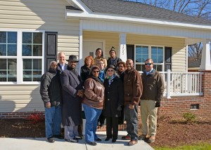 Posing in front of the newly dedicated home are, in front, from left, Zelodis Jay, chairman of the Granville County Board of Commissioners; Calvin "CJ" Harris, mayor pro tem of Oxford; Kim Simmons; Ruby Powell Greene; Bruce Simmons; and Granville County Habitat for Humanity board member Bonn Williams; on second row, from left, Habitat board member Gloria Boone, Habitat executive director Julie Booth and Habitat board president Cheryl Hart; and in back, from left, VGCC President Dr. Stelfanie Williams and Carpentry program head Keith Tunstall. (VGCC photo)