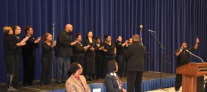 A choir under the direction of VGCC Public Services department chair Steve Hargrove performs during the VGCC Martin Luther King Jr. Holiday program. At far right is soloist and VGCC student Leonte Parker. Seated in front, from left, are VGCC Criminal Justice program head William Clements and VGCC president Stelfanie Williams. (VGCC photo)