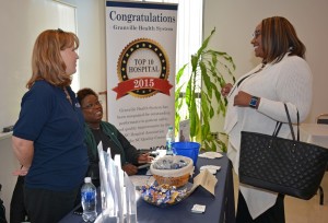 From left, Melanie Hobgood (standing) and Brenda Whitlock from Granville Health System talk with VGCC Associate Degree Nursing student Fara Vass of Henderson during the Health Sciences Career Fair. (VGCC photo)