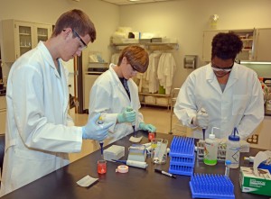 From left, students Justice Shuta of South Granville High School, Sarah Meixner of Granville Early College High School, Victoria Richardson of Warren County High School practice their micropipetting technique during the 2015 VGCC Biotech Workshop. (VGCC photo)