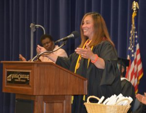 Melissa Elliott of Henderson addresses VGCC Adult Basic Skills graduates. In background, left, Vanessa Barrett interprets Elliott’s remarks in American Sign Language. (VGCC photo)