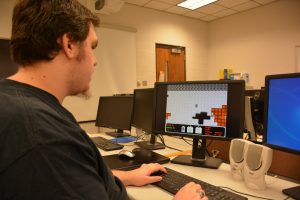 VGCC student Dustin Starnes plays “Vanguard Dreamer,” a video game that he helped create himself, in a VGCC computer lab. (VGCC photo)