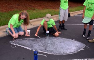 Science Camp participants paint a depiction of a protozoan (a type of microorganism) on a parking lot on VGCC’s Main Campus. (VGCC photo)