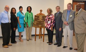 VGCC officials pose with the dedication plaque for Building 10 during the Aug. 3 ceremony. They include, from left, VGCC Dean of Continuing Education Dale Fey, Dean of Business & Applied Technologies Angela Gardner-Ragland, Vice President of Academic & Student Affairs Dr. Angela Ballentine, President Dr. Stelfanie Williams, outgoing Board of Trustees Chair Deborah Brown, incoming Chair Danny Wright, Vice-Chair Herb Gregory and Building Committee Chair Abdul Sm Rasheed. (VGCC photo)