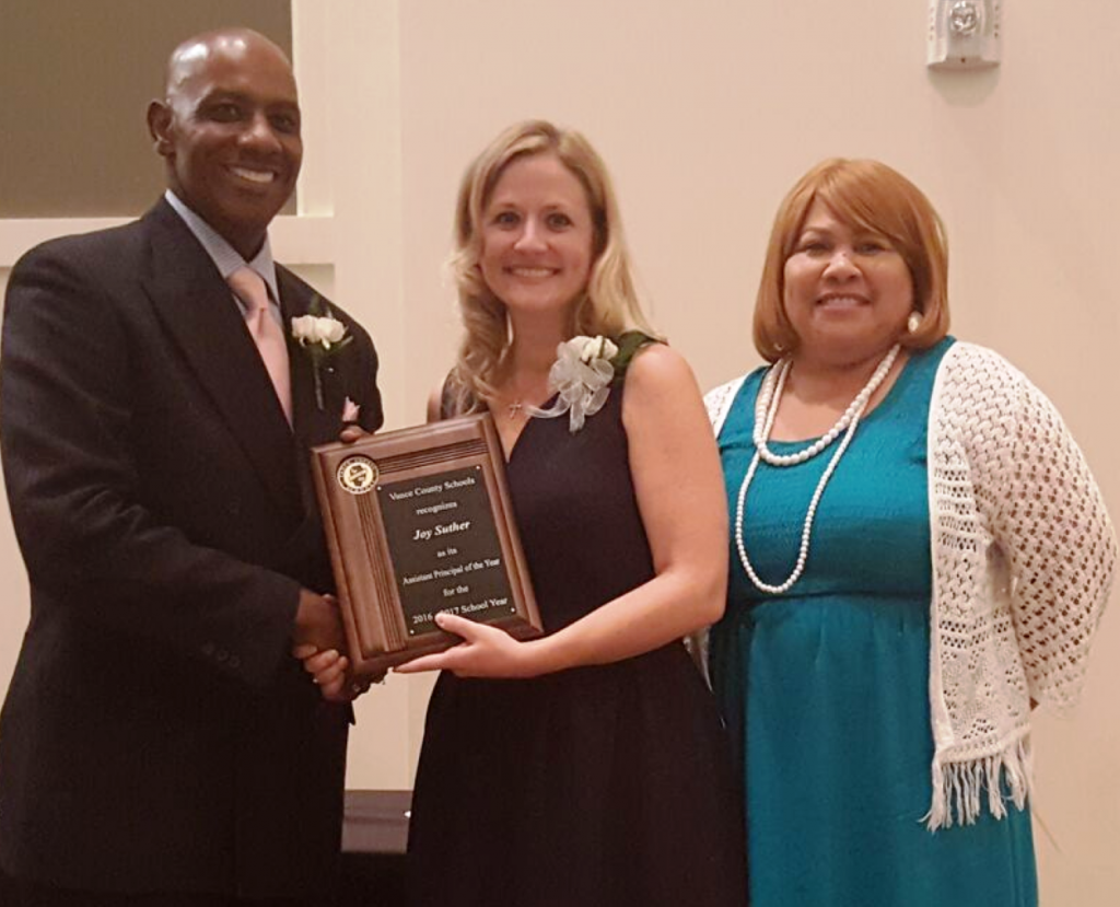 Joy Suther of Dabney Elementary School, center, accepts the 2016-2017 VCS Assistant Principal of the Year plaque from Jackson and White.