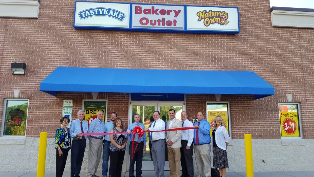 Shown at the ribbon cutting for Flowers Baking Company are, President, Mike McCall; Directory of Sales, Vice President of Sales, Tony Ufland; Don Brown; Retail Sales Manager, Dreama Sweat; Sales Manager, Billy Stevenson; Mayor Eddie Ellington; Jenny Hester, PRIM Development & Rentals; HVCC Director of Membership, Annette Roberson; President Vance Construction Company, Bob Kemp; and other staff and community business leaders. Not Pictured: Ryan Hedrick, The Daily Dispatch.