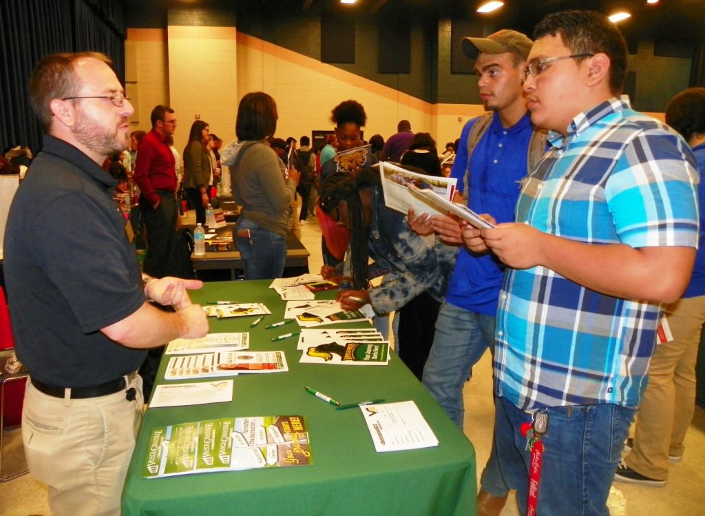 Spence Bailey of Vance-Granville Community College, left, talks with two Southern Vance High School students about future educational opportunities during the College Fair.