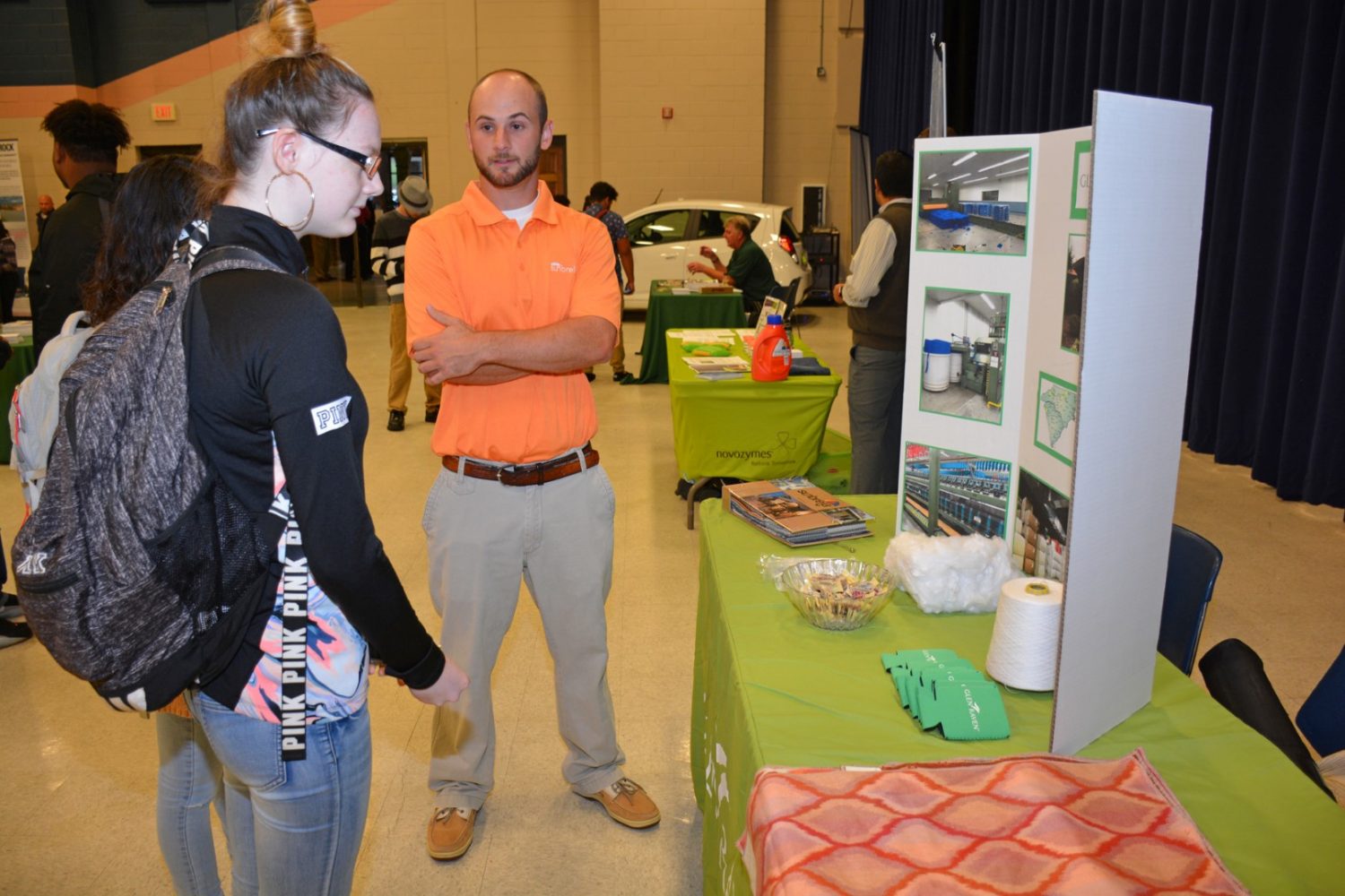 Zach Harris (center), an electrician at Glen Raven in Norlina, talks with students attending Manufacturing Day at VGCC. Harris studied Air Conditioning, Heating & Refrigeration Technology at VGCC. (VGCC photo)